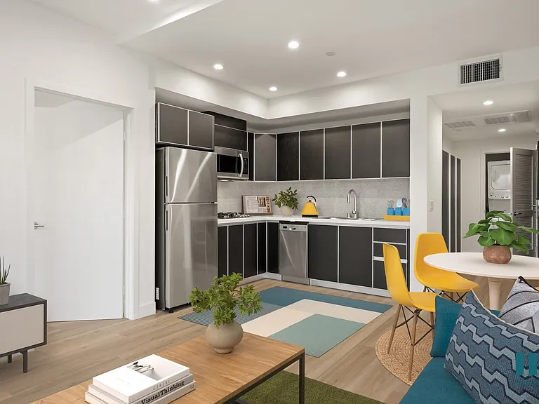 Open-Concept Kitchen with a Stainless-Steel Refrigerator, Dishwasher, Stove Range, and Microwave Oven - Magnolia Floor Plan