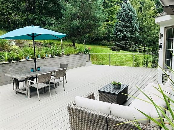 A mature acre homesite provides plenty of privacy for an enjoyable afternoon or evening on the impressive composite deck with mo
