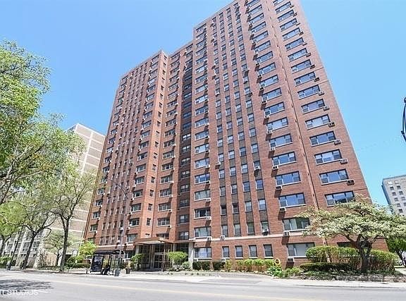 Front of building with door-person and available parking