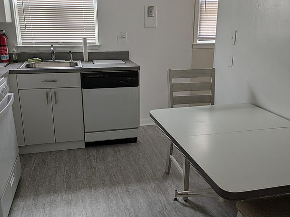 kitchen with microwave dishwasher and stainless steel sink oven/range and refrigerator freezer (image shot from dining room entrance to kitchen)
