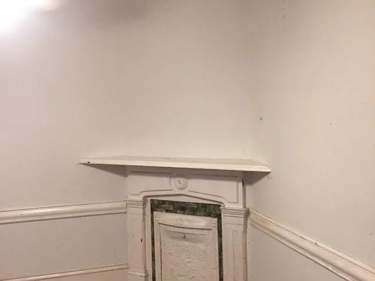 Bedroom with sealed fireplace and mantle, tenant can paint room any color. Currently white.