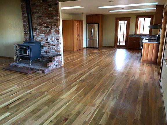 Large great room with wood burning fireplace.