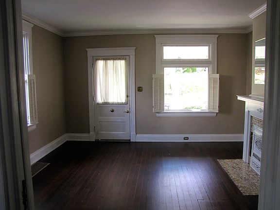Living room has a lot of light and original pine floors