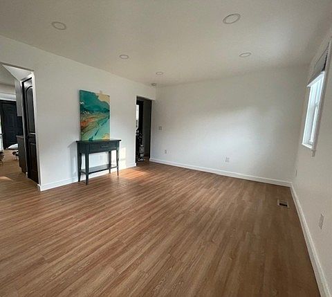 Living Room with recessed lighting, new floors, and electrical for mounting your flat screen TV.