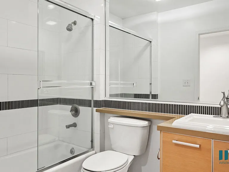 Bathroom with Shower Bath with Glass Door and Vanity Cabinet Storage