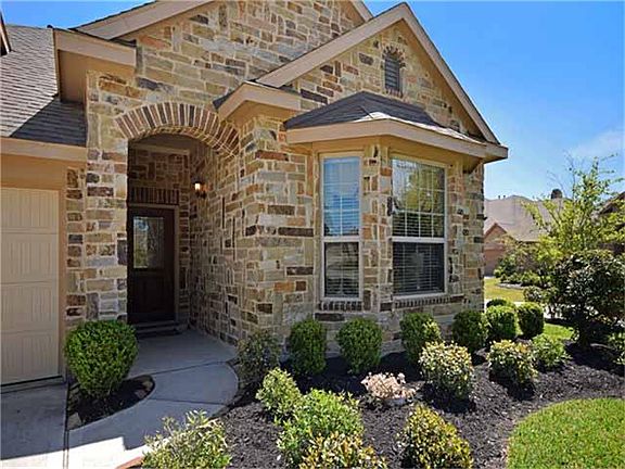 Beautiful stone elevation and professional landscaping highlight the entrance.