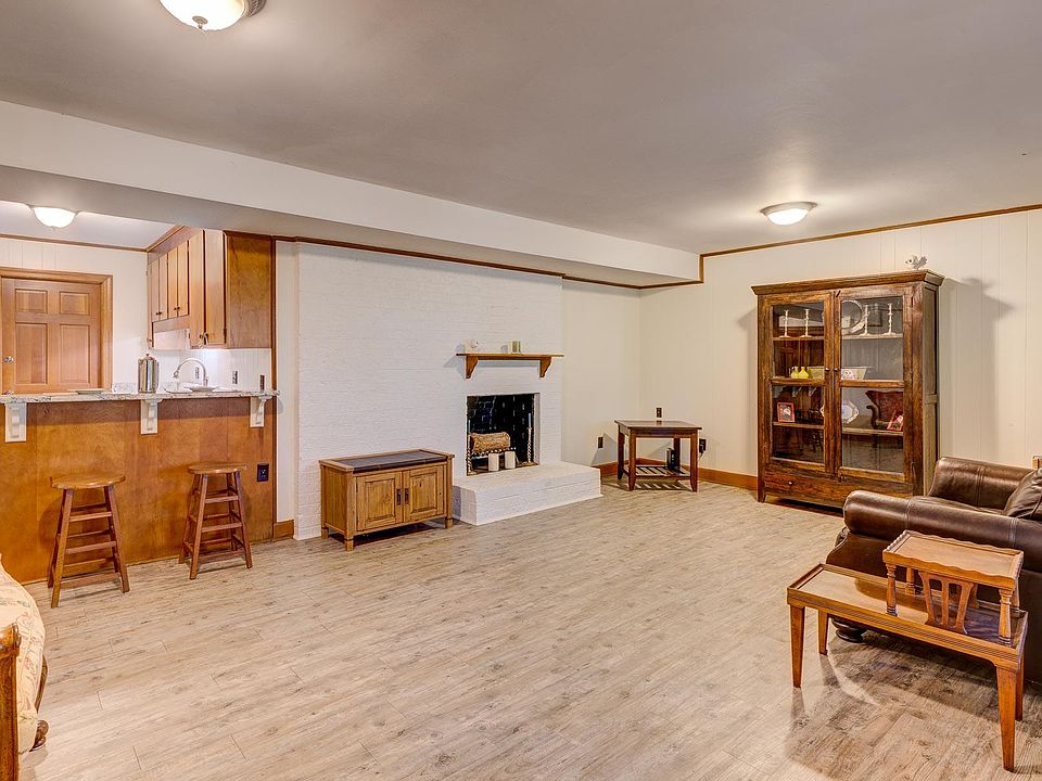 LR, DR, Kitchen open floor plan with luxury, vinyl plank flooring, and fireplace (Fireplace is not for use.) Only leather couch included.
