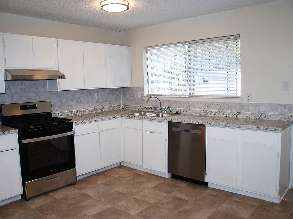 Brand new stove, dishwasher, countertops, sink and flooring