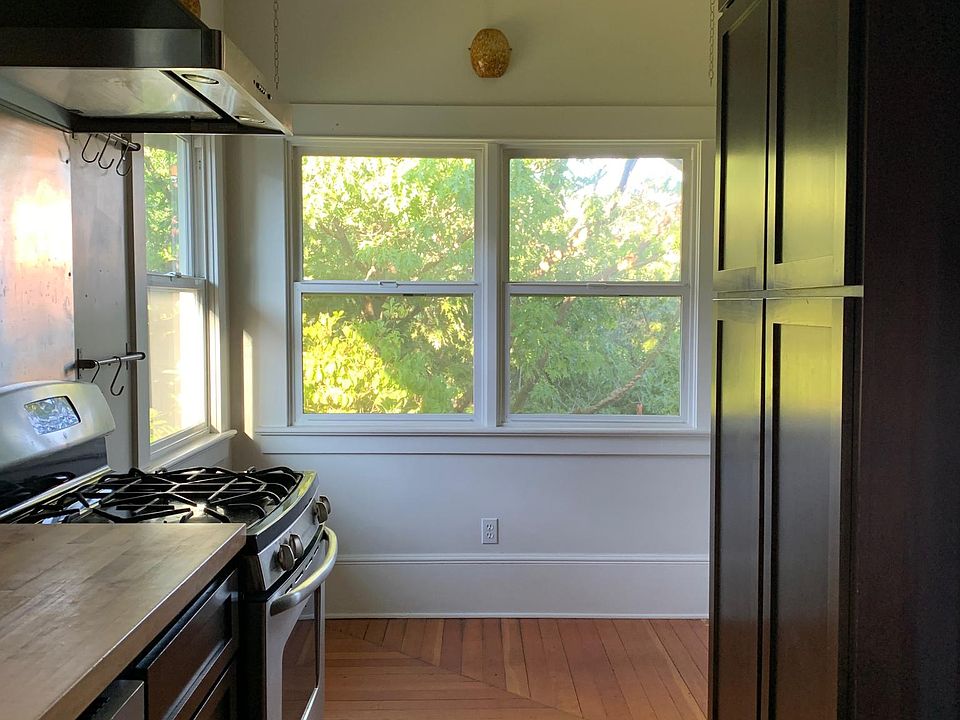 Gas stove with hood. Cozy light-filled breakfast nook.