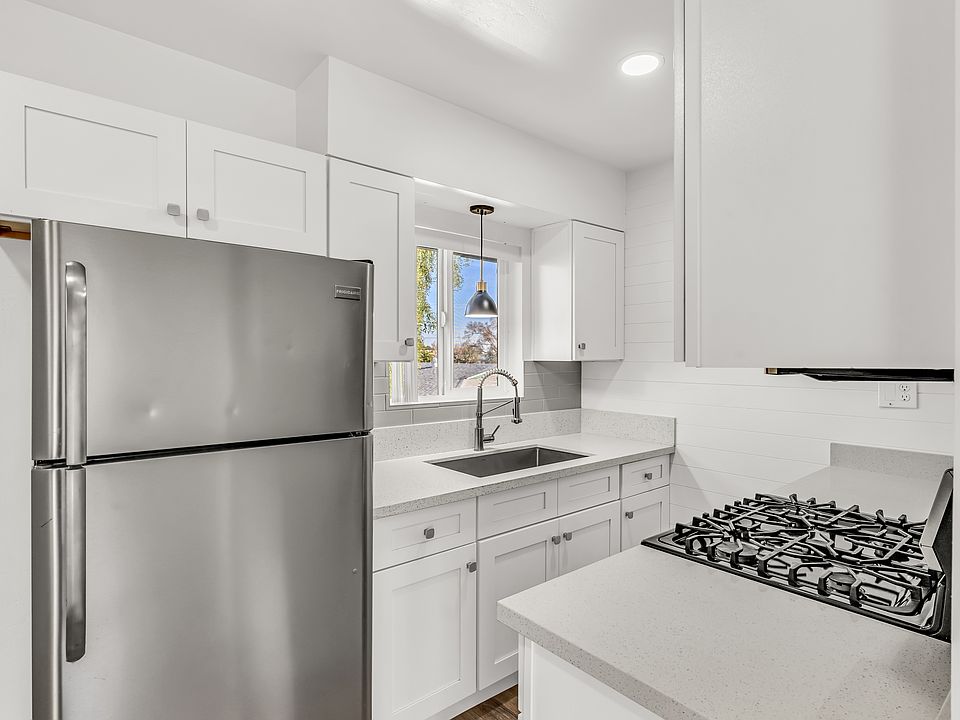 Upgraded kitchen features modern cabinetry, quality appliances.