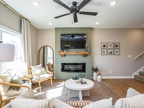 living room featuring open concept layout, decorative mantle and electric fireplace