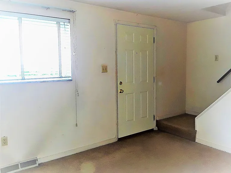 Front entrance door into large bright living room