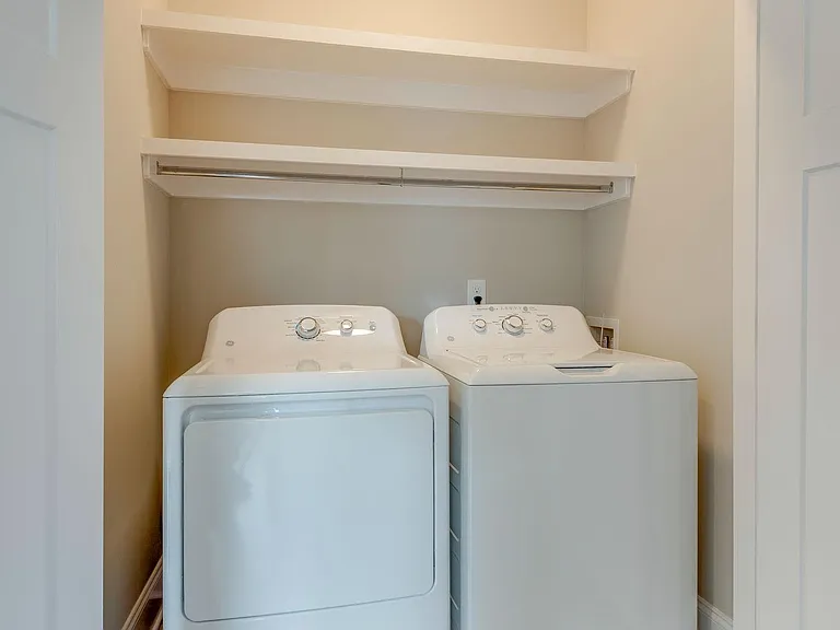 Laundry room with new appliances, tucks out of sight behind closet doors.