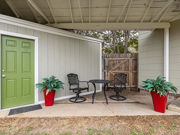 Covered back patio and side entrance to garage.