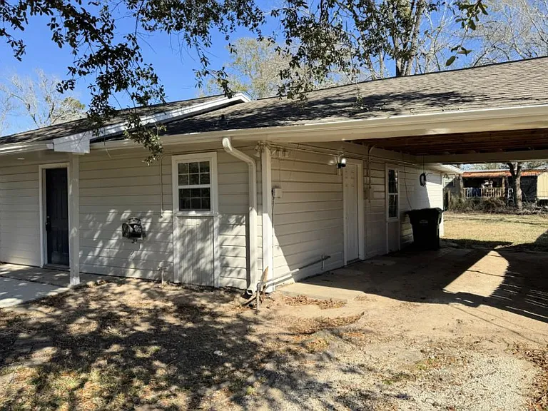 Covered parking and right side of house.