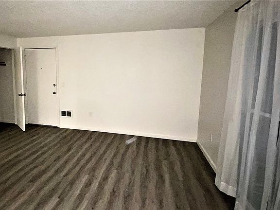 living room view of front door and coat closet