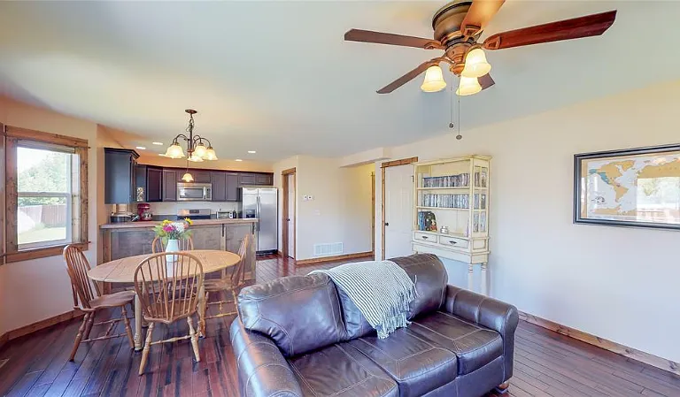 The high ceiling accentuates the living area space to the kitchen, where a 1/2 bath is also included