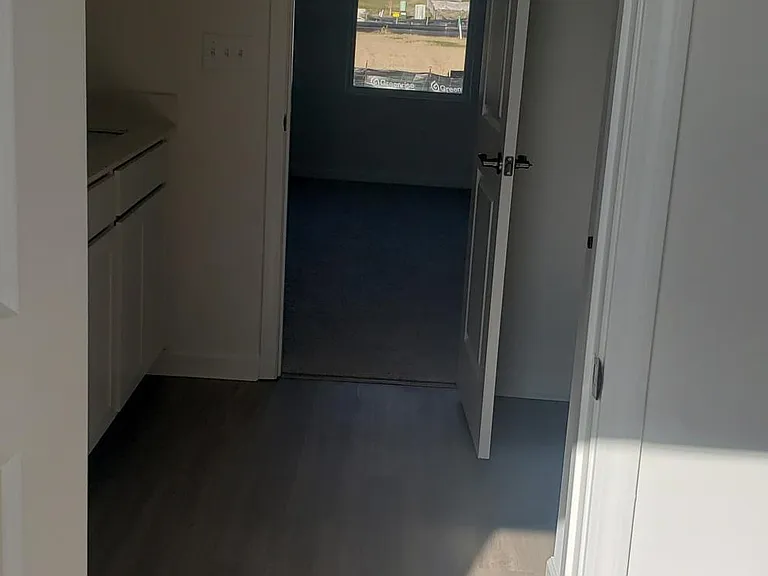 Owner's closet looking through bathroom into bedroom