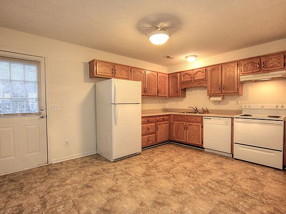Kitchen with washer dryer hookup located in a closet (flooring is now all wood and has been updated to match)