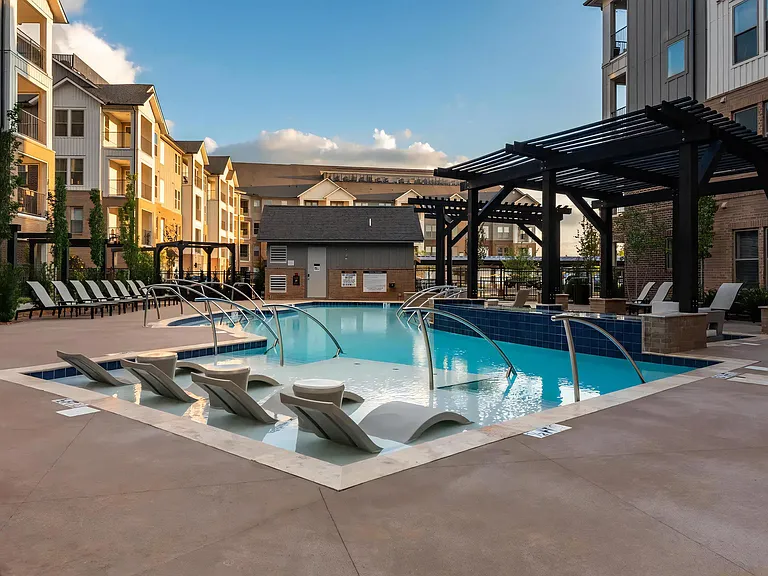 Relaxing Poolside Ambiance with Built-In Lounge Chairs at Dusk