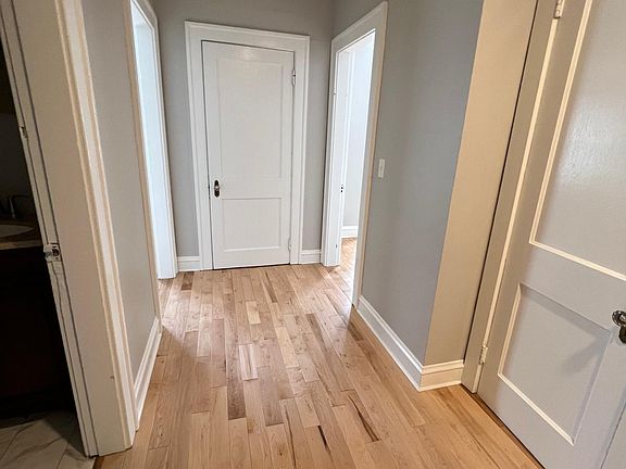 Hall with 2 closed, closet doors showing