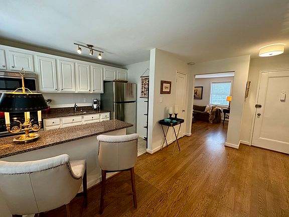 Dining Room opens to large Living Room with wonderful windows.