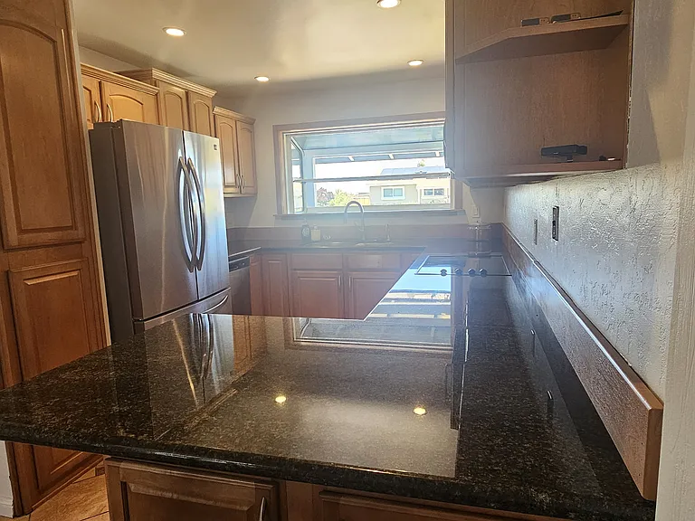 another view of the kitchen showing the window overlooking the street