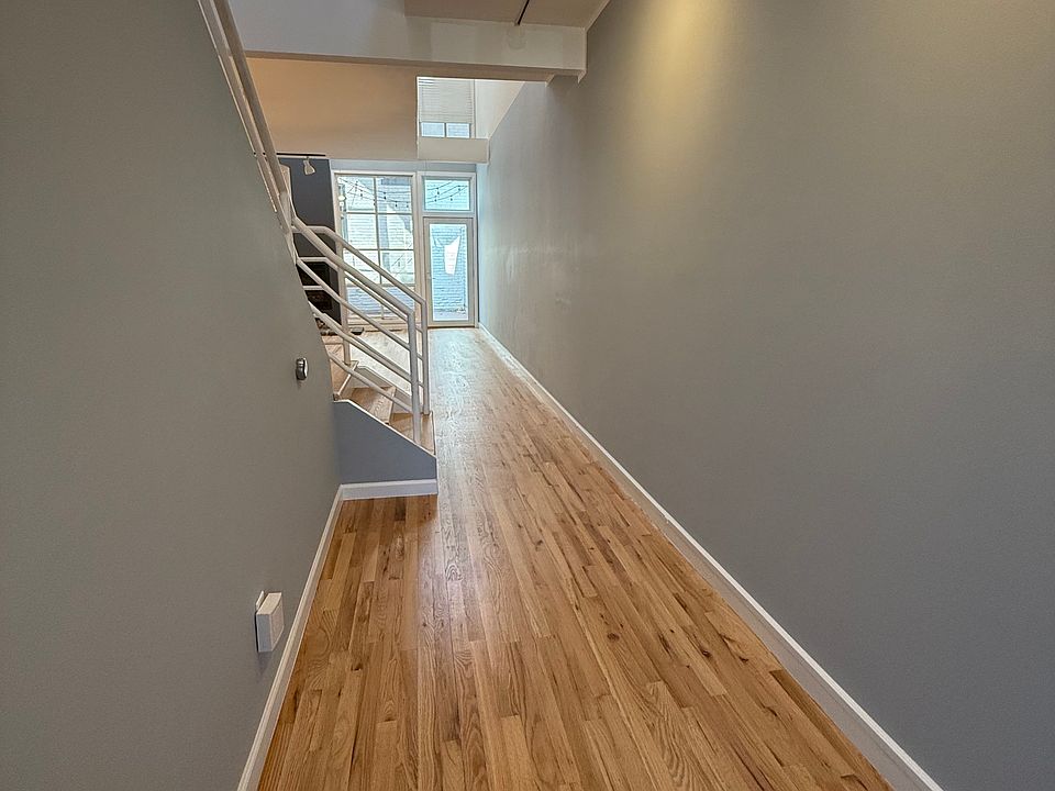 Entryway, freshly installed and finished hardwood floors and fresh paint