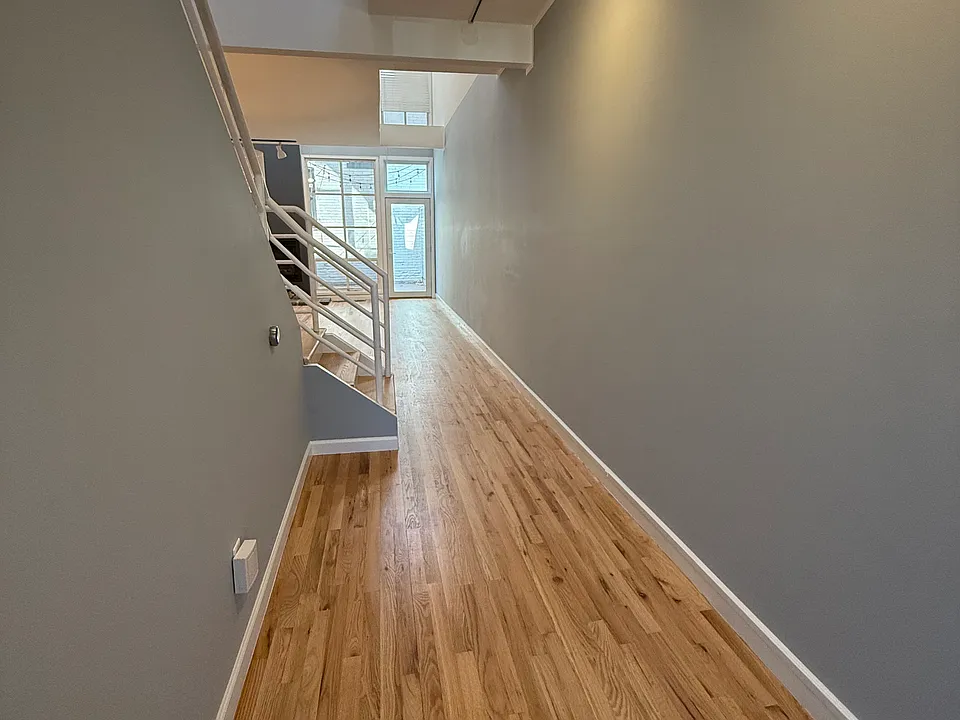 Entryway, freshly installed and finished hardwood floors and fresh paint