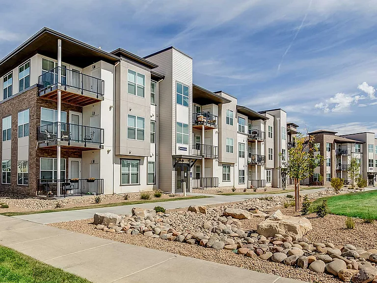 Modern residences at The Wright feature clean architectural lines, private balconies, and expansive green space in the heart of Centennial.