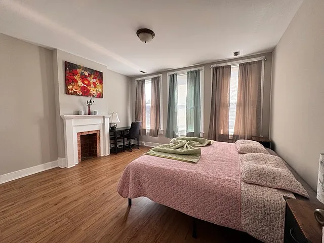 Huge Master Bedroom, lots of light and a work desk and chair with a lamp to do your work if needed before retiring for the night in a comfortable king bed. Big closet on the left.