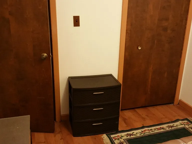 Staged 2nd bedroom, view from window at back of room. Door on the left is bedroom door. Door on the right is closet