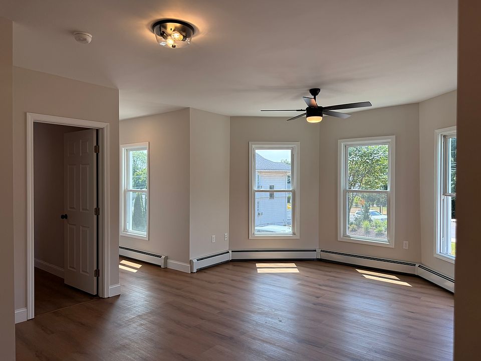 LIVING ROOM - large beautiful windows, tons of natural light and lots of space. All new fixtures and finishes.
