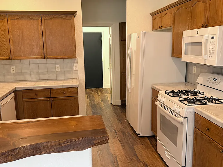 Kitchen looking towards laundry and door to garage