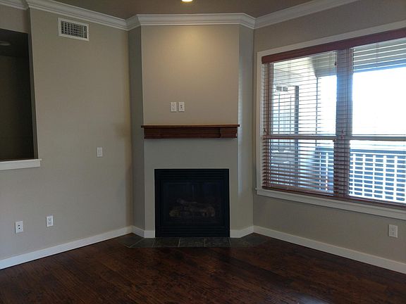 Gas fireplace and view of the balcony patio
