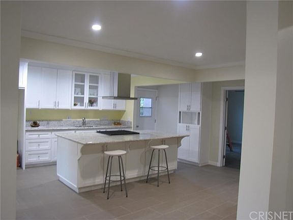 Spacious and beautiful new kitchen with recess lighting, center cooking area with plenty of room for
