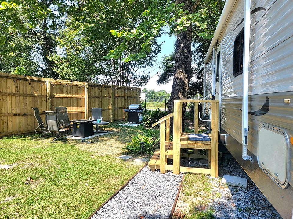 Gravel walkway & wood Steps are inside the fenced yard.