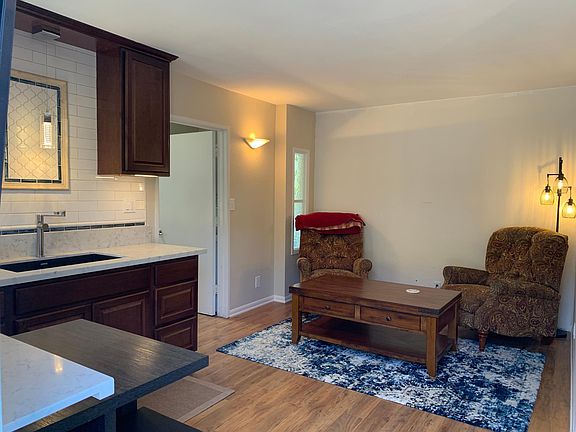 Furniture has been ordered, it will have a large couch, glass coffee table, pictures.