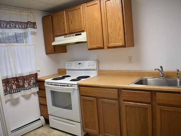 Kitchen: Refrigerator, stove/oven, sink, upper and lower cabinets.