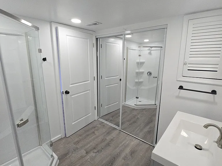 Master bathroom inside looking at shower, closet and back of door going out of shower