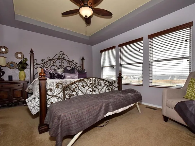 Master bedroom with full bathroom and double sinks.