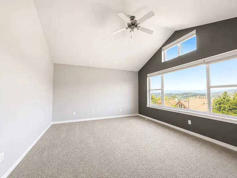 Primary bedroom with vaulted ceilings and an incredible mountain view. You'll love waking up to this view every morning!