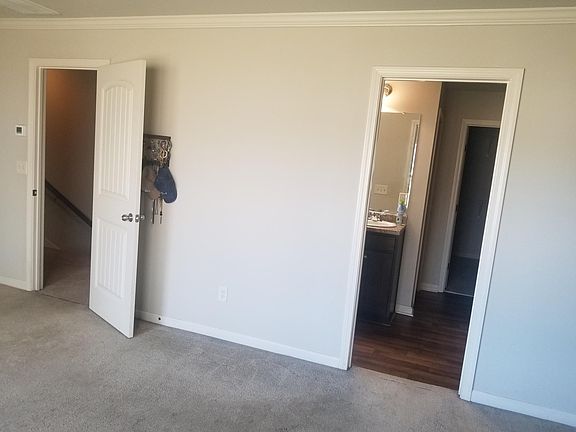 Master bedroom view of exit (left) and bathroom door (right)