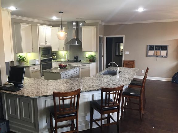 Large open kitchen with granite countertops and island. Cab