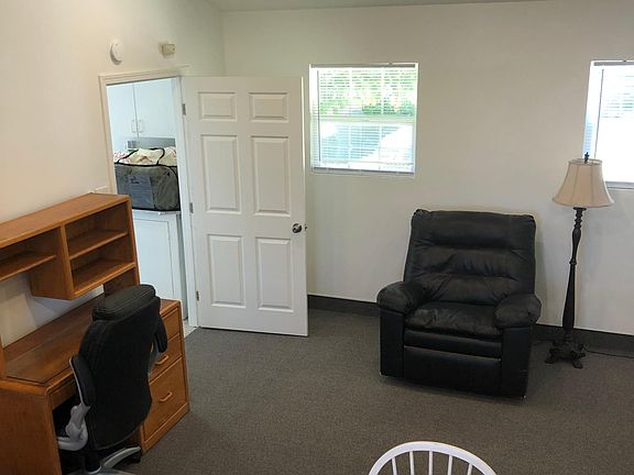 Desk, bookshelf, Lazy Boy, washer and dryer in next room