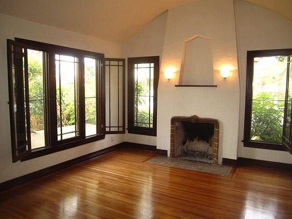 living room with original wood windows & working fireplace