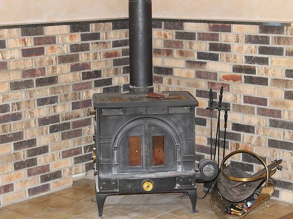 Wood burning stove with blower.  Vaulted ceiling.  Doors leading out to deck.