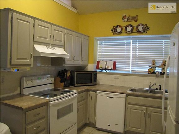 Cute Kitchen with painted cabinets & tile floor