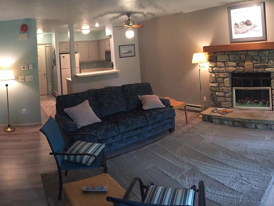Good view of living room and kitchen. Beautiful doors to outdoor porch on the right. View updated photos with current furniture.