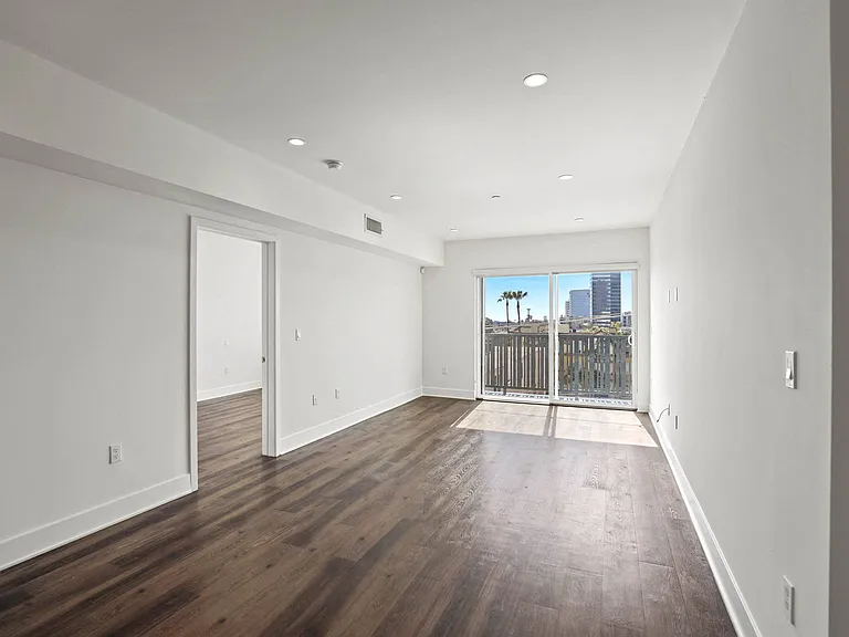 Spacious Living Room with Recessed Lighting and Vinyl Flooring